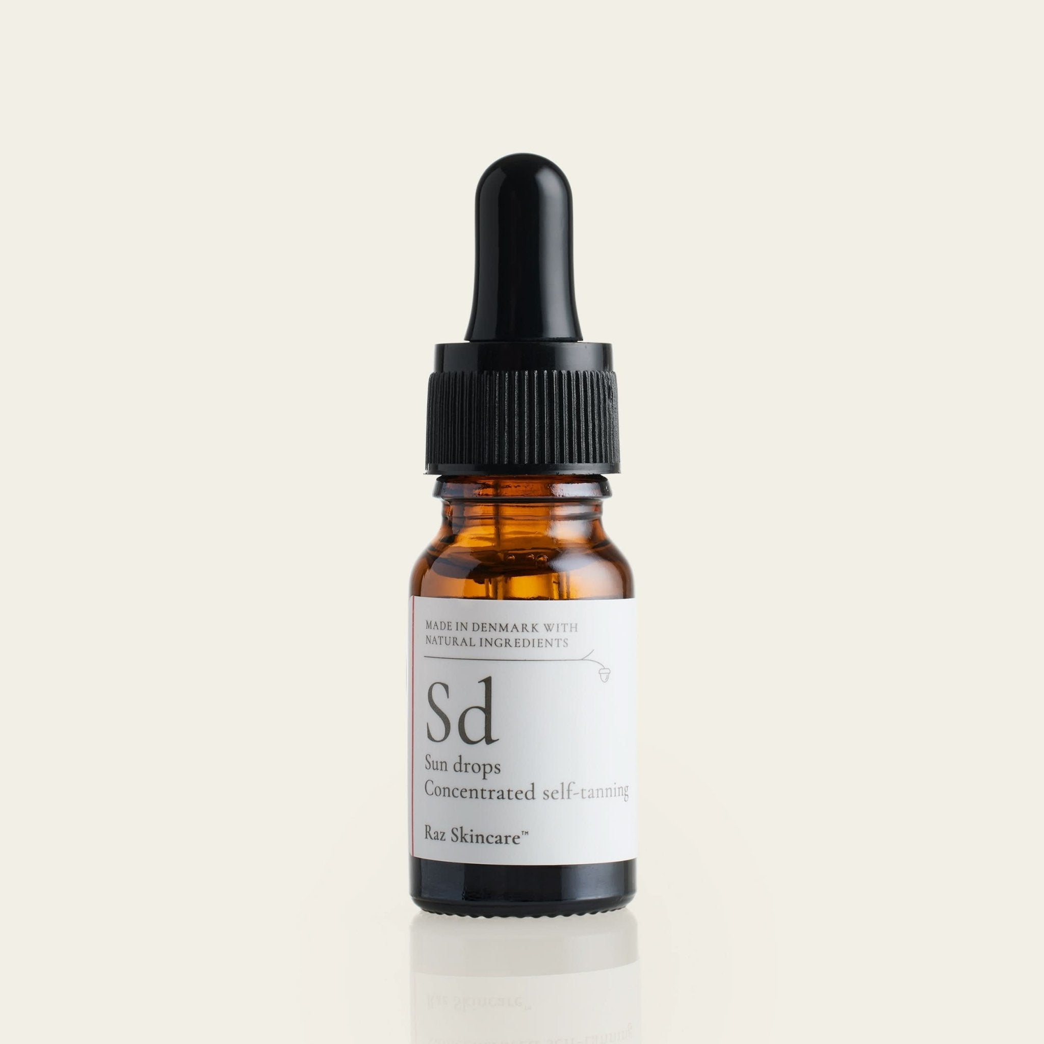 Sd Sun Drops 10ml - Raz Skincare - placeret foran en beige baggrund