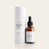 Mdh 30ml ved siden af siden sin flotte indpakning, med en beige baggrund